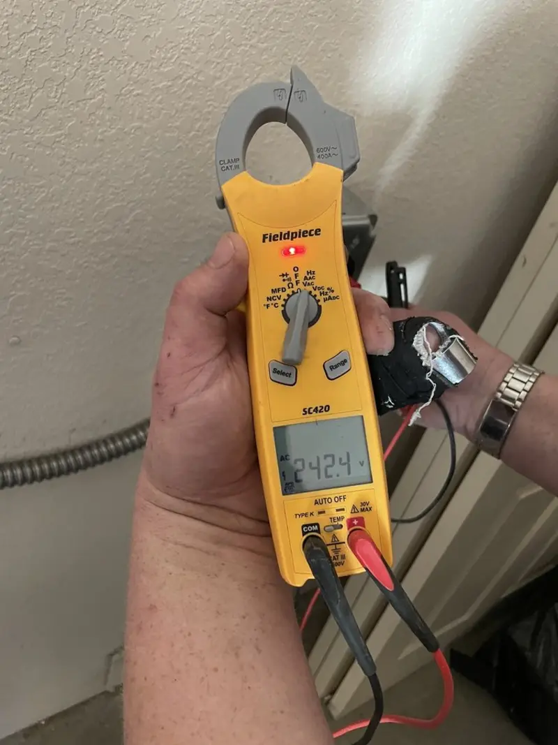 Voltage testing with clamp meter during Ceiling Fan Installation in Dawson
